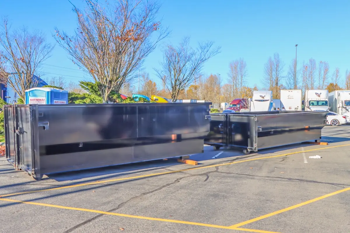 Professional dumpster rental service with roll-off container on residential driveway in New Rochelle